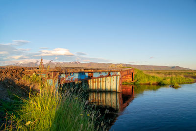 Bridge over water against blue sky