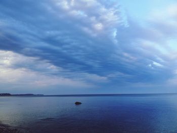 Scenic view of sea against cloudy sky