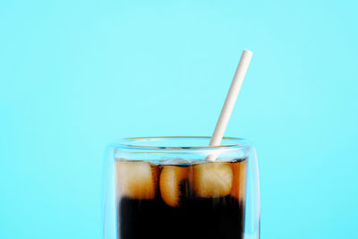 Close-up of drink against blue background