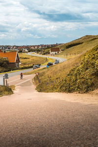 Road amidst buildings against sky