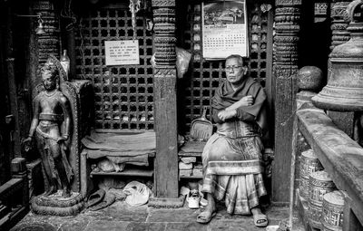 Senior woman sitting in old buddhist temple