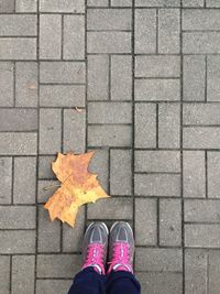 Low section of person standing on footpath