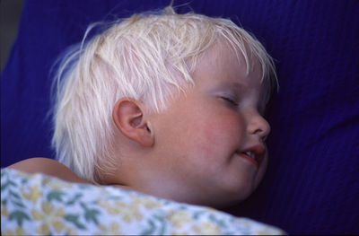 Portrait of cute boy sleeping on bed