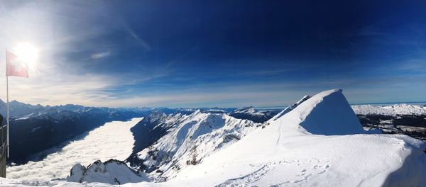 Snow covered mountain against blue sky