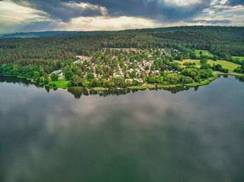 Aerial view of lake by landscape against sky