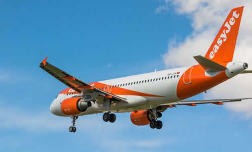 Low angle view of airplane flying against sky