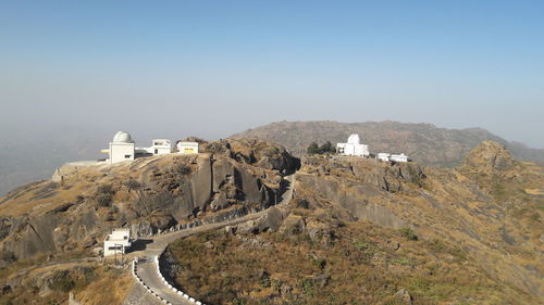 Castle on mountain against clear sky