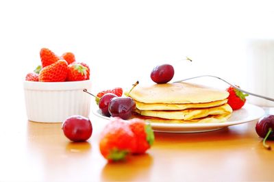 Close-up of strawberry over white background