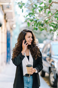 Young woman using mobile phone outdoors