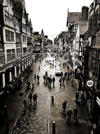 High angle view of people walking on street amidst buildings in city