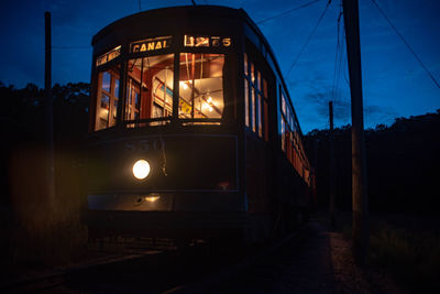 Train on illuminated railroad track at dusk