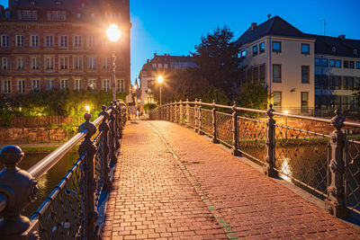 Rear view of man walking on street at night