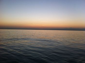 Scenic view of sea against clear sky during sunset