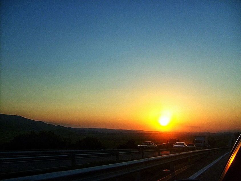 sunset, transportation, scenics, road, orange color, copy space, clear sky, tranquil scene, tranquility, beauty in nature, landscape, mountain, nature, sky, sun, the way forward, idyllic, highway, no people, travel