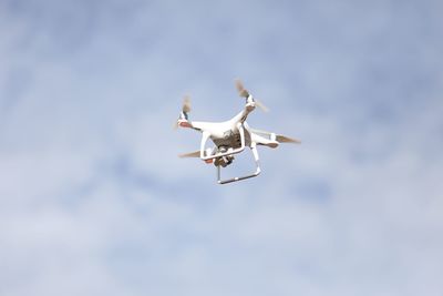 Low angle view of airplane flying against sky