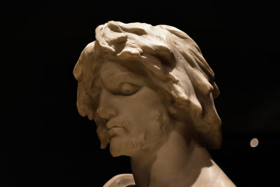 Close-up of statue against black background