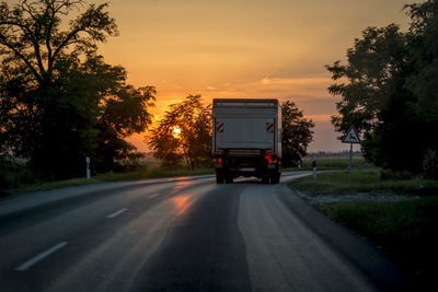 Car on road against sky during sunset