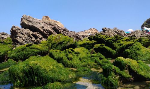 Scenic view of rocks against clear blue sky