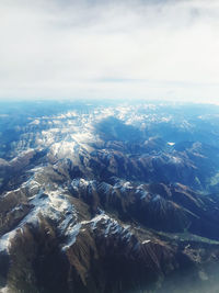 Aerial view of sea and mountains against sky