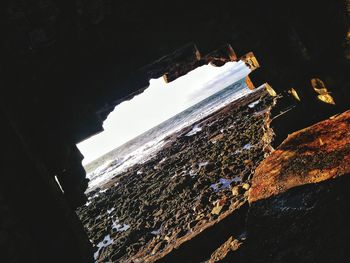 Scenic view of sea seen through cave