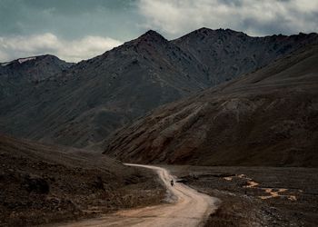 Scenic view of mountains against cloudy sky