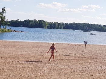 Full length of man on beach against sky