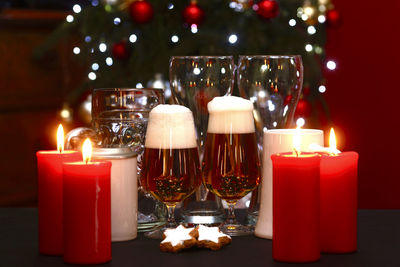 Close-up of lit candles on table