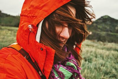 Close-up of woman with red hair standing outdoors