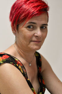 Portrait of smiling woman against gray background