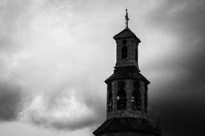 Low angle view of tower against cloudy sky