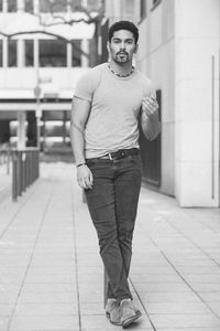 Portrait of man standing against buildings