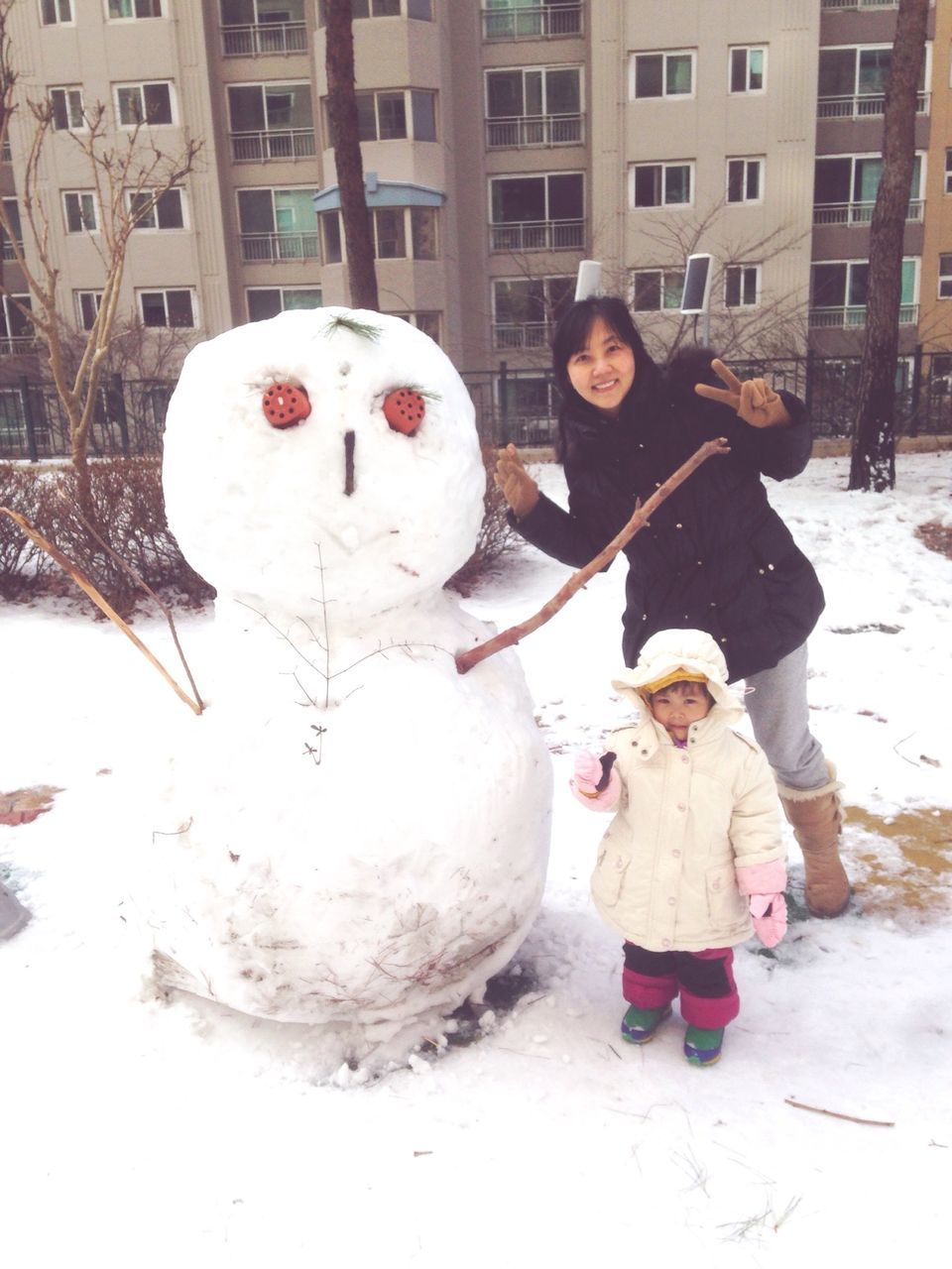 winter, snow, cold temperature, building exterior, season, built structure, weather, architecture, childhood, full length, human representation, street, lifestyles, creativity, day, warm clothing, person, outdoors