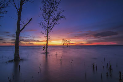 Scenic view of sea against sky at sunset