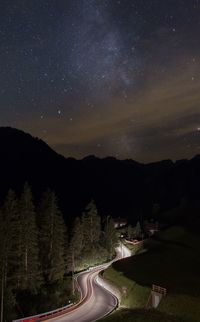 Scenic view of illuminated mountains against sky at night