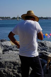 Rear view of woman standing on beach