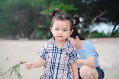 Portrait of cute boy lying on land