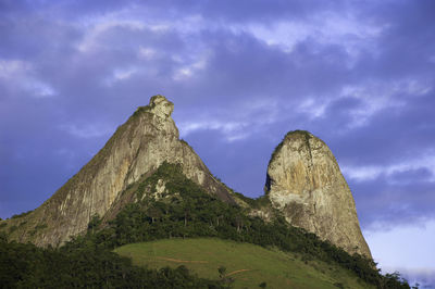 Low angle view of rocks on mountain against sky