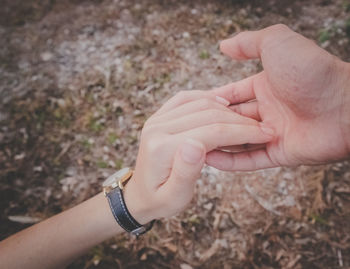 Midsection of couple holding hands