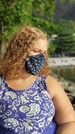 Woman wearing mask standing outdoors