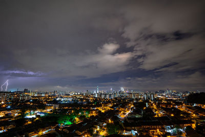 High angle view of illuminated city against sky at night