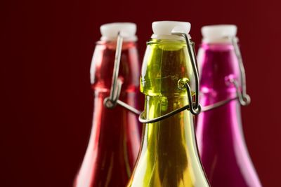 Close-up of drink bottle against red background