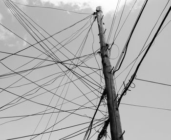 Low angle view of electricity pylon against sky