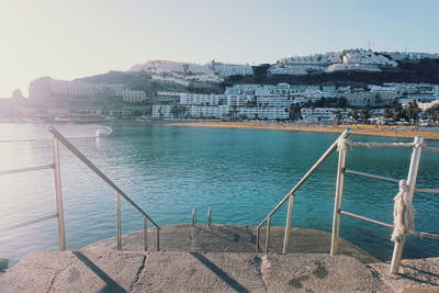 View of town by sea against clear sky