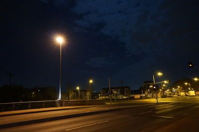 Illuminated road in city at night
