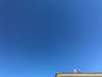 Low angle view of building against clear blue sky