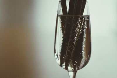 Close-up of wineglass against white background