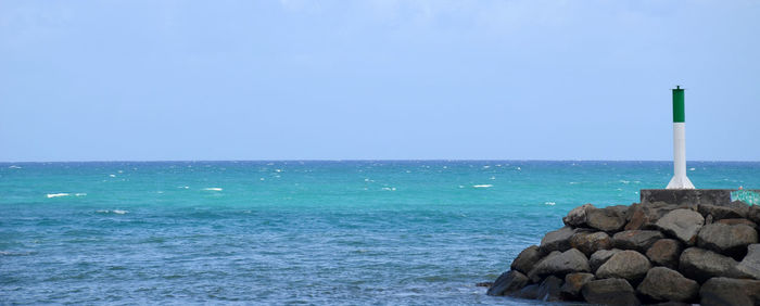 Scenic view of sea against clear blue sky