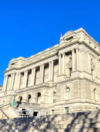 Low angle view of historical building against blue sky