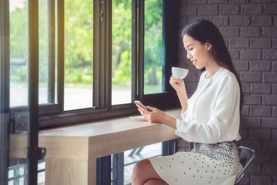 Young woman drinking coffee at home