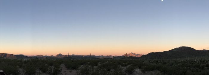 Scenic view of mountains against clear sky during sunset